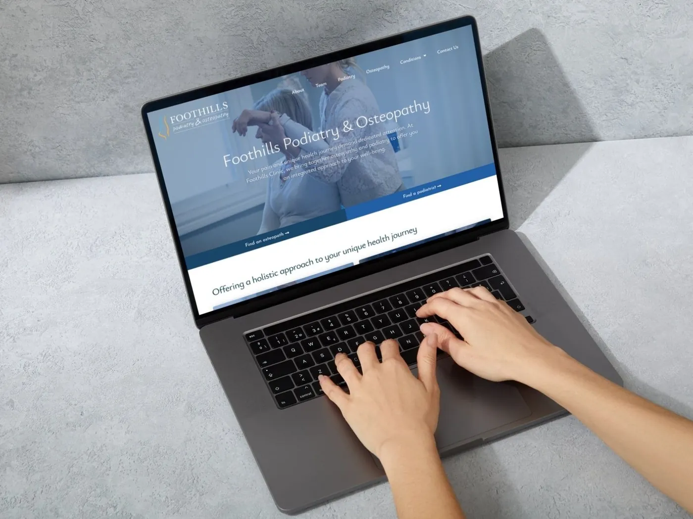 Foothills Podiatry and Osteopathy website on a laptop, designed by SKCREATIVE in Melbourne
