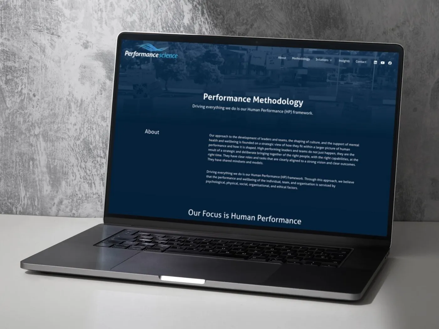 Human performance consultancy website on a laptop, designed by SKCREATIVE